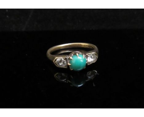 A gold ring with cabochon turquoise flanked by diamonds, marks rubbed. Size G, 2.7g