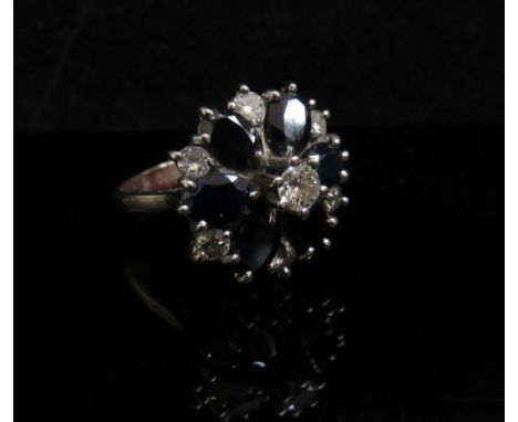 A white gold diamond and sapphire cluster ring, stamped 18ct. Size O, 6.4g