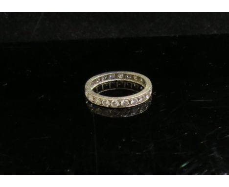 A diamond eternity ring, unmarked platinum. Size J, 2g