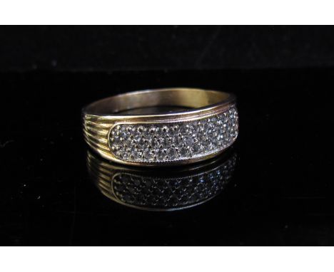 A 9ct gold ring with three rows of cubic zirconia. Size Z, 3.9g 