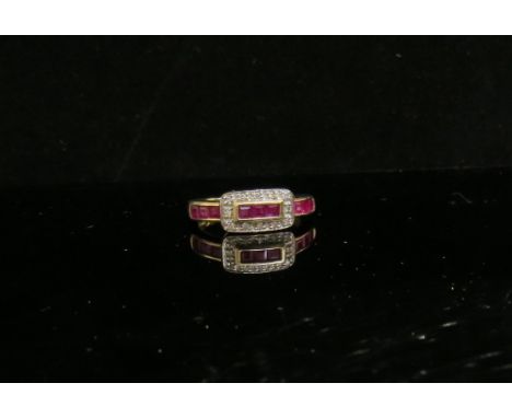 A 9ct gold ruby and diamond buckle style ring. Size N/O, 2.4g