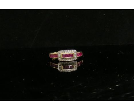 A 9ct gold ruby and diamond buckle style ring. Size N/O, 2.4g