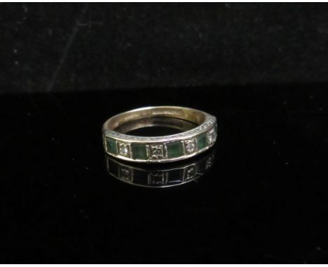 A 9ct gold diamond and emerald half hoop ring. Size L/M, 2.2g