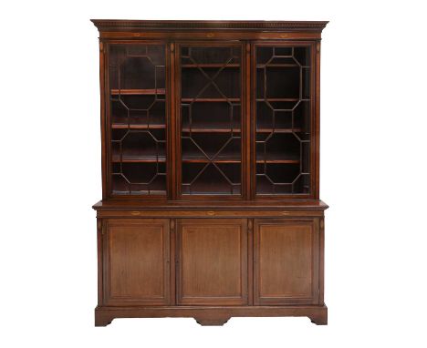 A Victorian Mahogany, Crossbanded, Boxwood and Ebony-Strung Three-Door Library Bookcase, late 19th century, the dentil cornic