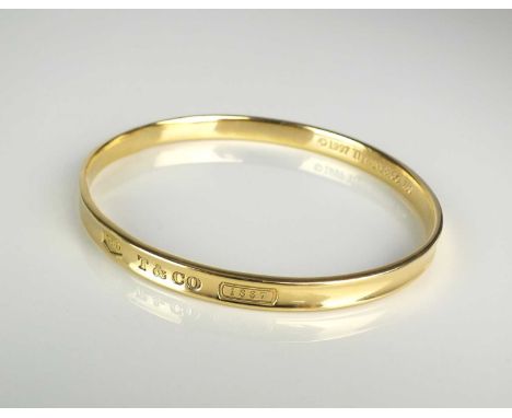 A Tiffany &amp; Co 18ct yellow gold bangle, the outer bangle inscribed '750 T &amp; CO 1837', the inner bangle inscribed '199