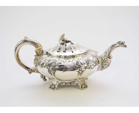 A George IV silver teapot, makers mark rubbed, London 1828, of compressed melon form with embossed floral decoration, the aca