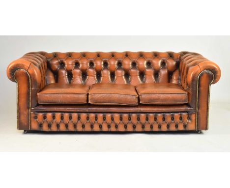 A tan leather Chesterfield suite, 20th centuryComprising a three-seat sofa and two armchairsSofa 191cm wide x 92cm deep x 68c