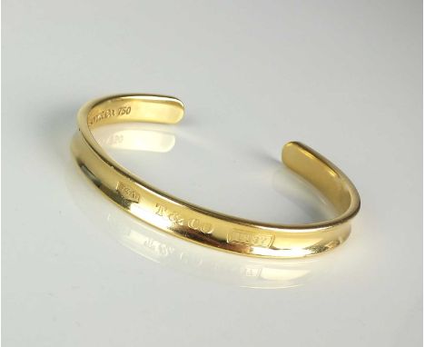 A Tiffany &amp; Co 18ct yellow gold torque bangle, the outer bangle inscribed '750 T &amp; CO 1837', the inner bangle inscrib