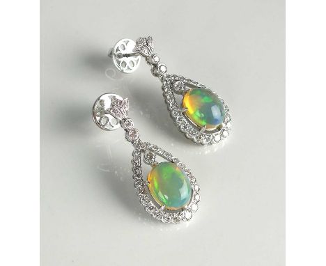 A pair of 18ct white gold opal and diamond earrings, each designed as a central oval cabochon water opal claw set within a pe