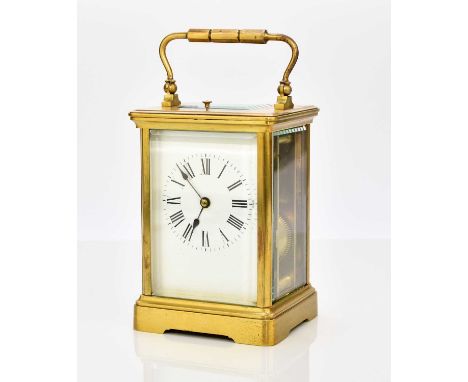 A French brass carriage clock with repeat, early 20th centuryThe case with carrying handle, the 2 1/2in white enamel dial wit