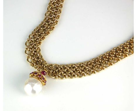 An 18ct gold necklace with baroque cultured pearl and ruby pendant, the yellow gold chain necklace formed as two rows of circ