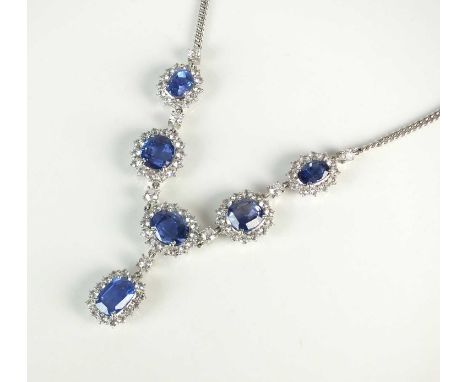 A blue sapphire cluster necklace, designed as five oval mixed cut sapphires claw set within a border of white round facted st