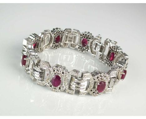 An Art Deco style ruby and diamond bracelet, designed as eight stylised geometric bow links set with a central oval mixed cut