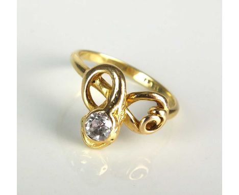An early 20th century diamond set snake ring, designed as a yellow metal stylised entwined snake with old cut diamond set hea