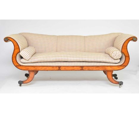 A George IV mahogany and satinwood sofaOf scroll-arm form, raised on outswept supports capped with brass claws and castors.22