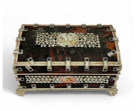 Indian bone and tortoiseshell work box, casket form with pierced bone and penwork panelling, raised on four claw feet. Height