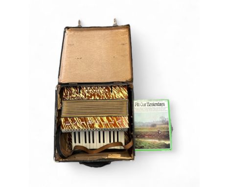 Estrella Accordion - Generally in excellent physical condition, with a brown and yellow striped pattern design. In a hard bac