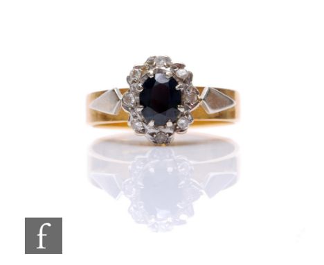An 18ct hallmarked sapphire and diamond cluster ring, central sapphire within diamond set border, weight 4.3g, ring size K.