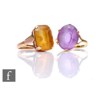 Two yellow metal stone set dress rings, each set with a yellow and purple facet cut stone, 1.5cm, ring sizes P and S, unmarke