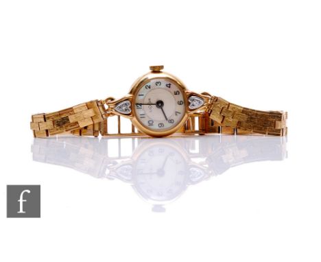 A 9ct hallmarked lady's Luxor manual wind wrist watch, Arabic numerals to a circular mother of pearl dial and a 9ct brick bra