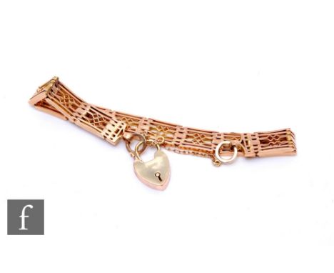 A 9ct rose gold fancy six bar gate bracelet, weight 19.5g, terminating in padlock fastener, slight damage.