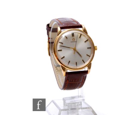 A 9ct hallmarked gentleman's Omega manual wind wrist watch, gilt batons to a silvered circular dial, case diameter 34mm, all 
