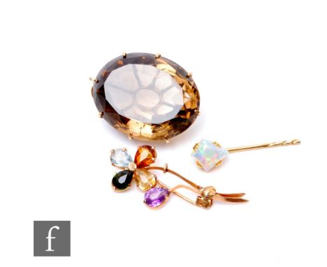 Three items of jewellery, a 9ct multi stone brooch modelled as a flower, a 9ct mounted smoky quartz pendant and an opal stick