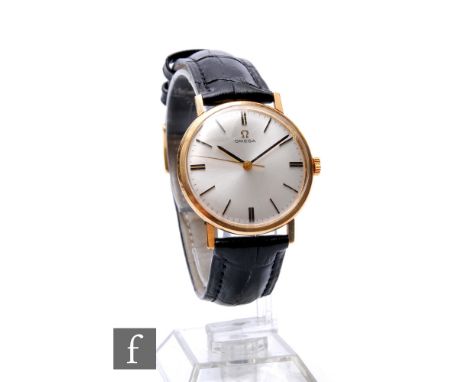 A 9ct hallmarked gentleman's Omega manual wind wrist watch, batons and date facility to a silvered circular dial, case diamet