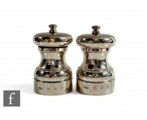 A hallmarked silver salt and pepper grinder each of plain baluster form, total weight 450g, heights 10cm, London 1980,&nbsp;M