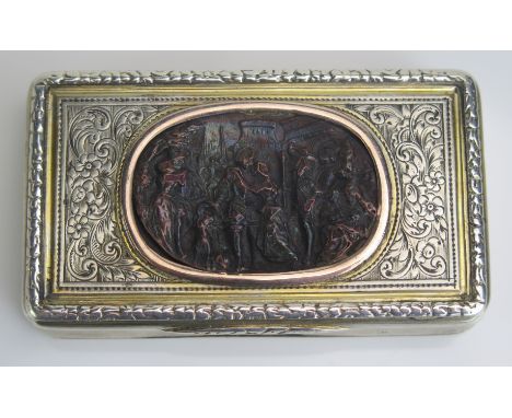 An early 19th century French parcel gilt and silver  snuff box, stamped marks, of rectangular form, the hinged lid with oval 