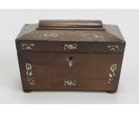 A 19th century rosewood and mother-of-pearl inlaid tea caddy of sarcophagus outline, the shallow domed hinged lid enclosing t