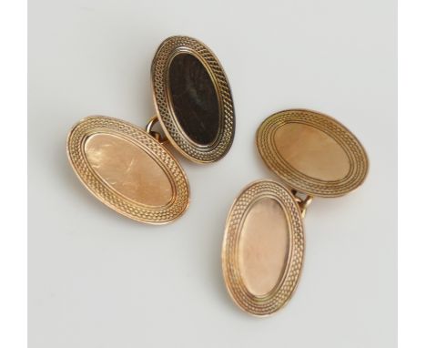 A Pair of 9ct Gold Cufflinks with engine turned decoration, hallmarked, 4.49g. Boxed