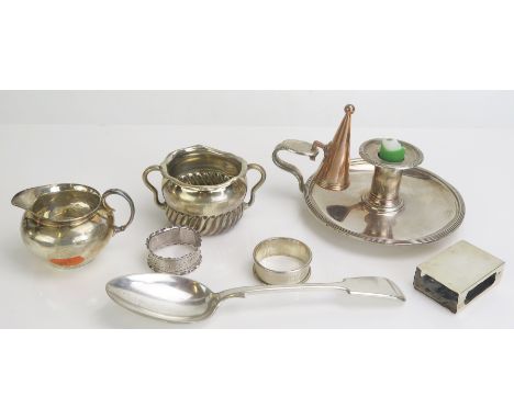 A sterling silver sugar bowl, silver matchbox holder, two napkin rings, plated chamber stick and a plated cream jug, total we