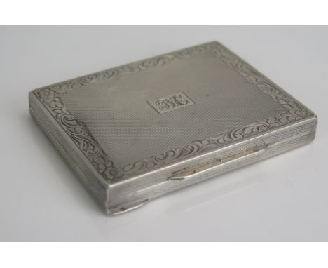 A continental silver card case, stamped marks, initialled, of rectangular outline, with engine turned decoration, 7-5cm wide,