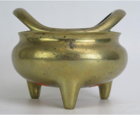 A Chinese bronze tripod censer, of circular form with swept handles, on three peg feet, bears apocryphal Xuande mark to the b