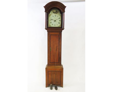 A 19th century oak longcase clock, the arched hood with turned columns, the trunk with cross banded door, on a box base, havi