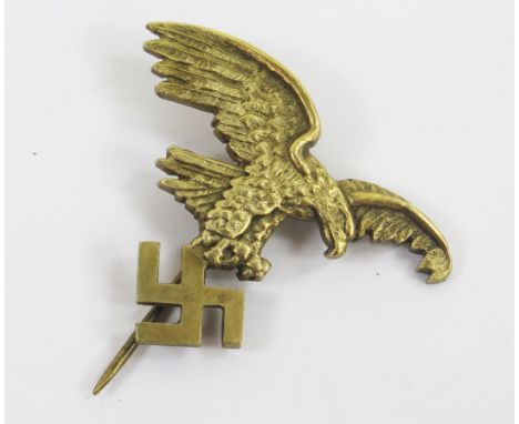 A World War II gilt brass Luftwaffe stick pin, of an eagle holding a swastika.