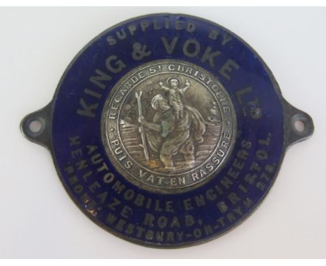 J R Gaunt, London, a metal and  enamel St Christopher car badge, supplied by Ling &amp; Voke, Automobile Engineers, Bristol, 