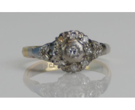 An 18ct Gold and Old Cut Diamond Cluster Ring in a white metal setting, size K.5, stamped 18CT, 2.88g. Boxed