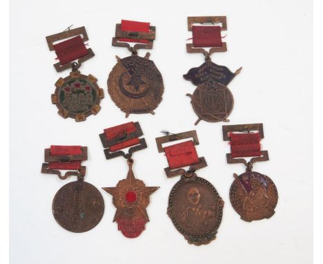 A collection of Chinese communist bronzed metal medals including Army medal