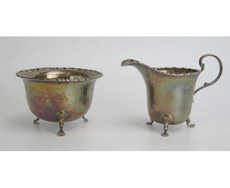 A George V silver cream jug and matching sugar basin, maker Adie Brothers Ltd, 97gms, 3.12ozs