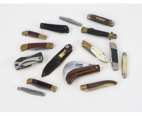 A collection of assorted folding pen knives, pocket knives, and pipe tampers.