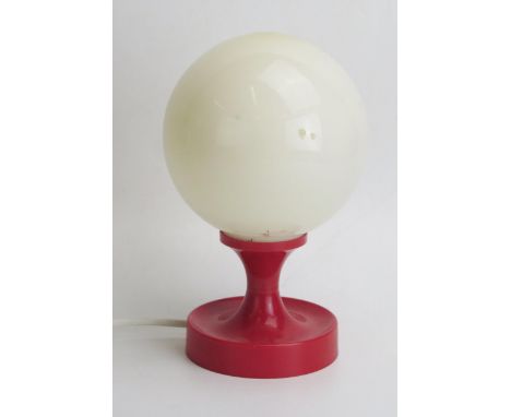 A West German red plastic vintage table lamp with opaque glass globe shade, 12.5cm high.