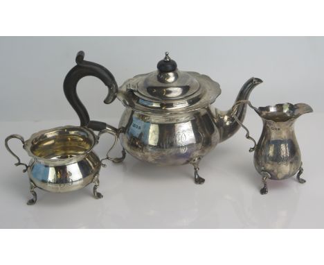 A George V silver three-piece tea set, maker Robert Pringle &amp; Sons, London, 1921, with wavy edge border, raised on swept 