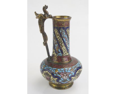A late 19th century bronze and champlevé enamel vase, of squat bulbous form, the handle surmounted by a dragon, 12cm high.