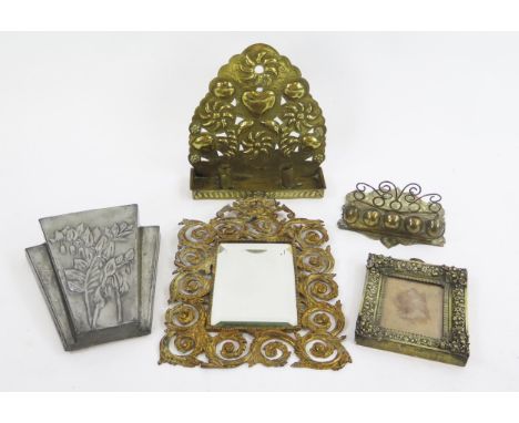 A Dutch brass wall candle holder, of arched outline 30cm high, a brass pipe holder, a metal wall pocket, brass easel framed m