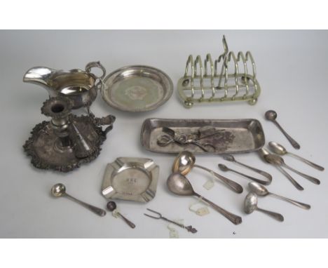 A mixed collection of silver and plated wares, includes silver caddy spoon, mustard spoons, ashtray, plated toast rack, chamb