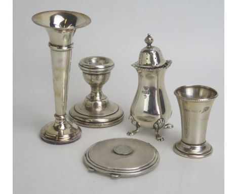 A mixed collection of silver wares, various makers and dates includes pepperette, specimen vase, desk candlestick, powder com