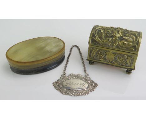 A19th century horn oval snuff box and cover 8cm wide, a brass vesta striker in the form of a casket, raised on bun feet, 6cm 
