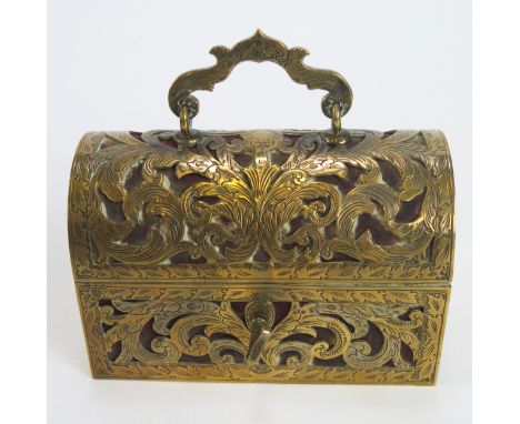 A brass mounted trinket casket, of rectangular outline, the domed hinged lid enclosing a velvet lined interior, with loop car